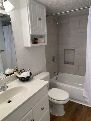 a bathroom with a sink a toilet and bathtub