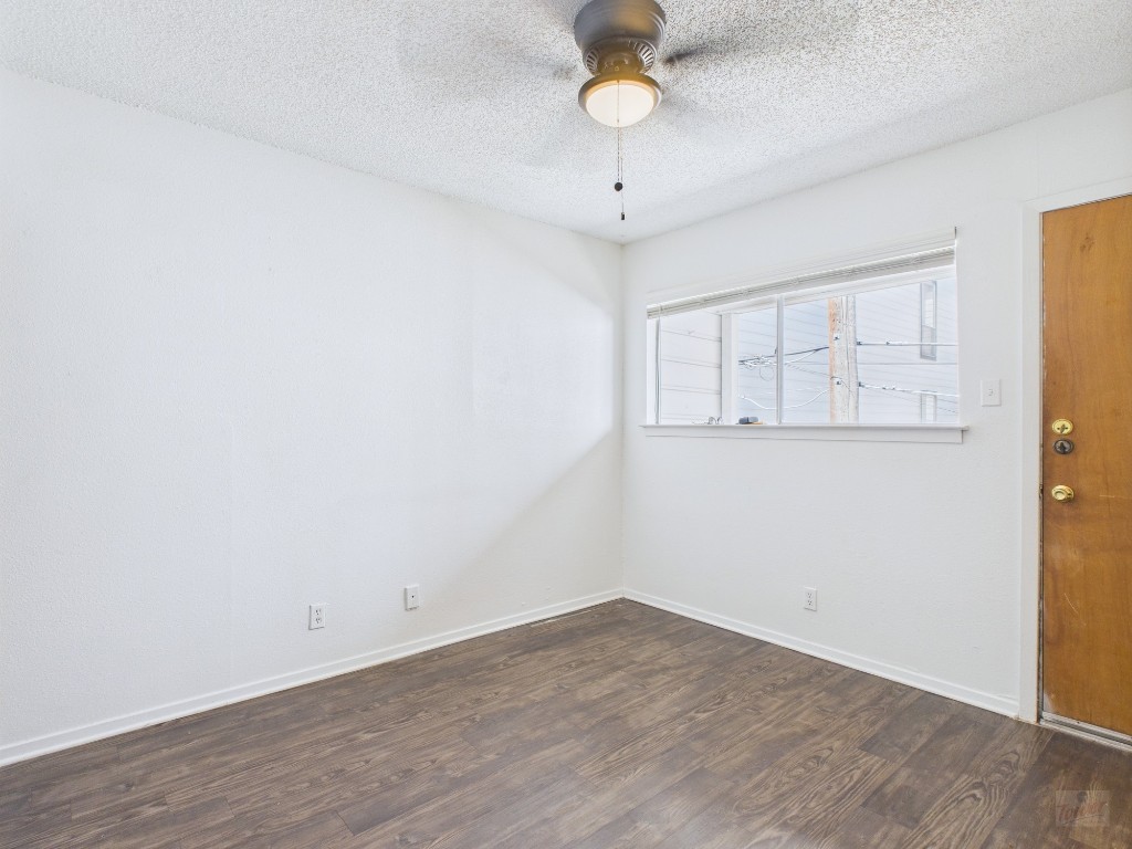 2808 Whitis Avenue, Unit C303 Austin, TX 78705 - Photo 6 of 21 an empty room with wooden floor and windows