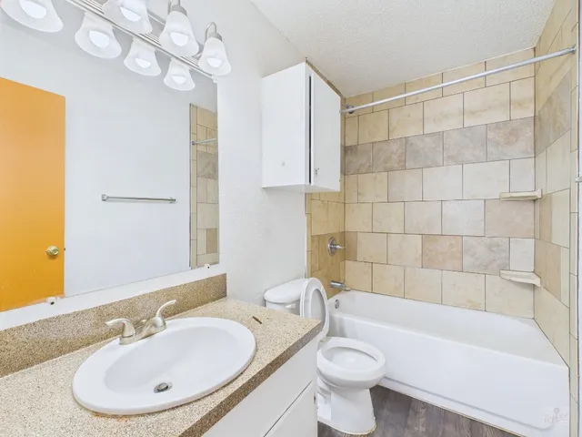 a bathroom with a sink a toilet and bathtub