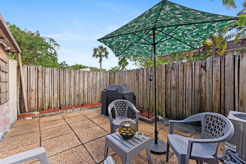 a backyard of a house with table and chairs