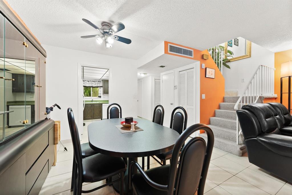 3320 Simms Street, Unit 11C Hollywood, FL 33021 - Photo 11 of 37 a dining room with furniture a chandelier and window