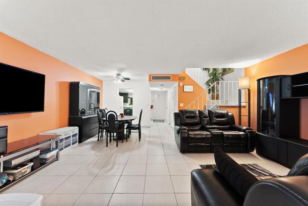 3320 Simms Street, Unit 11C Hollywood, FL 33021 - Photo 12 of 37 a living room with furniture and a flat screen tv