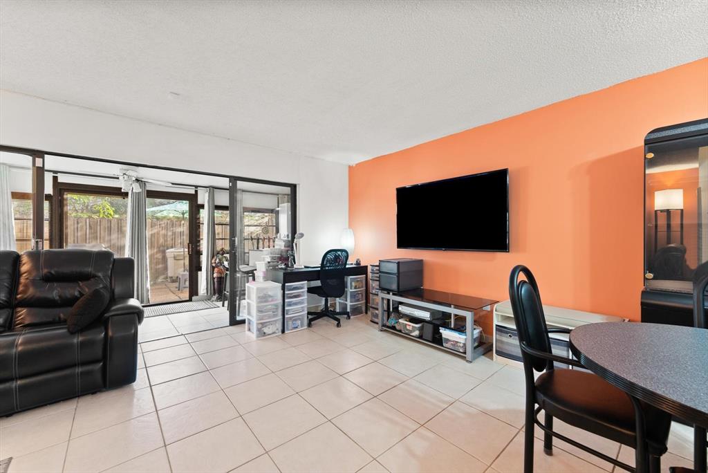 3320 Simms Street, Unit 11C Hollywood, FL 33021 - Photo 14 of 37 a living room with furniture and a flat screen tv