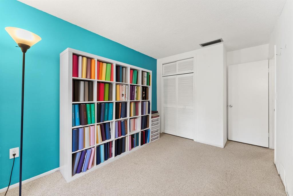 3320 Simms Street, Unit 11C Hollywood, FL 33021 - Photo 20 of 37 a living room with a book shelf and a book shelf