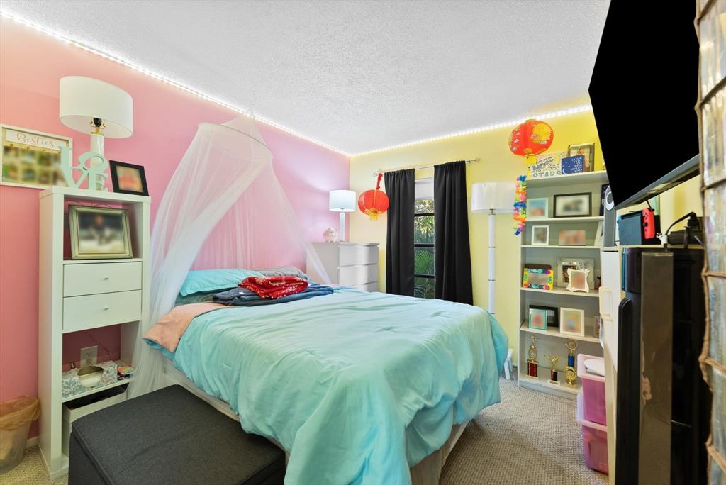 3320 Simms Street, Unit 11C Hollywood, FL 33021 - Photo 22 of 37 a bedroom with a bed and cabinets