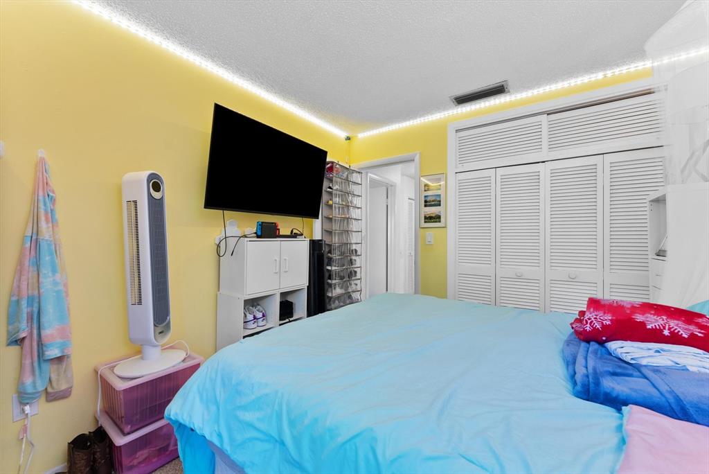 3320 Simms Street, Unit 11C Hollywood, FL 33021 - Photo 23 of 37 a bedroom with a bed and flat screen tv