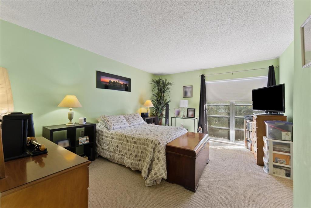 3320 Simms Street, Unit 11C Hollywood, FL 33021 - Photo 24 of 37 a bedroom with bed and flat screen tv