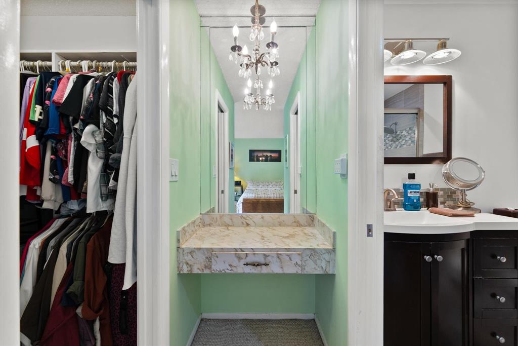 3320 Simms Street, Unit 11C Hollywood, FL 33021 - Photo 26 of 37 a view of walk in closet with clothes and shoes