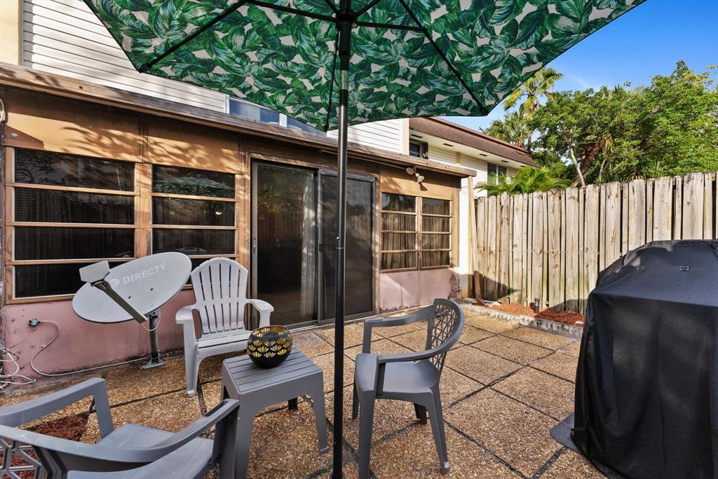 3320 Simms Street, Unit 11C Hollywood, FL 33021 - Photo 29 of 37 a view of a patio with a table chairs and a potted plant