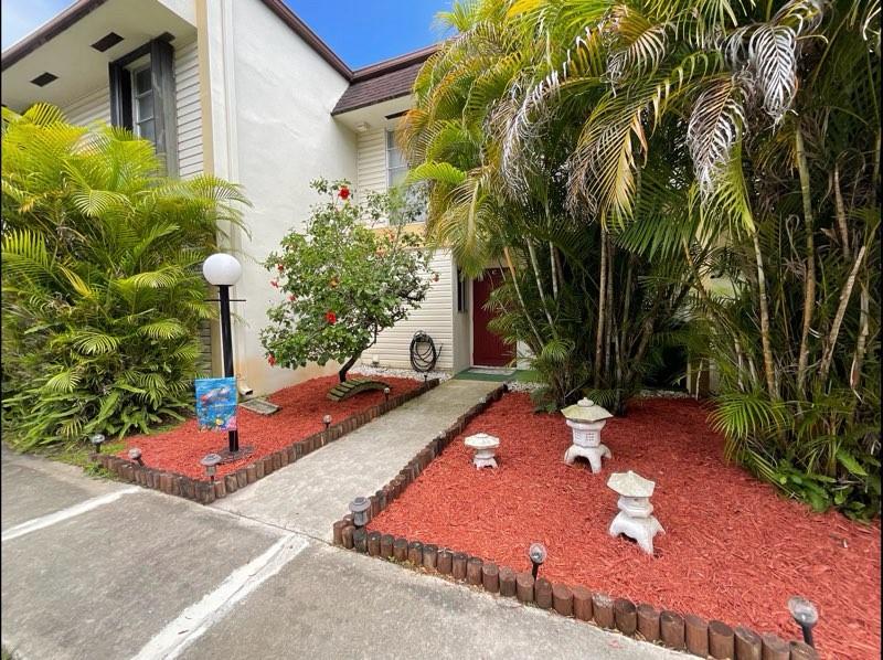 3320 Simms Street, Unit 11C Hollywood, FL 33021 - Photo 37 of 37 a backyard of a house with yard and outdoor seating