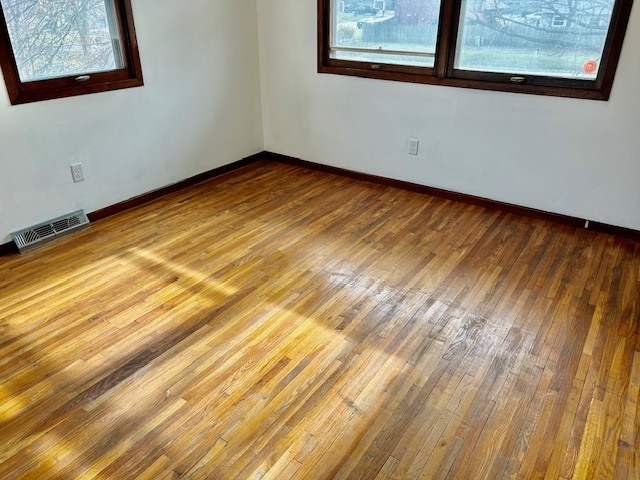 1515 6 Points Road Bloomington, IL 61701 - Photo 28 of 29 a view of an empty room with wooden floor and a window