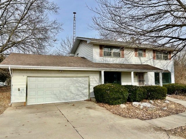 1515 6 Points Road Bloomington, IL 61701 - Photo 3 of 29 a front view of a house with a yard and garage