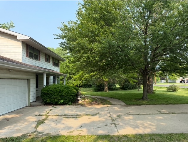 1515 6 Points Road Bloomington, IL 61701 - Photo 32 of 33 a backyard of a house with plants and trees