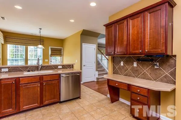 a kitchen with stainless steel appliances a sink and cabinets