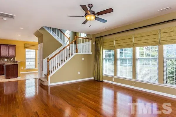 a view of an entryway with wooden floor and a ceiling fan
