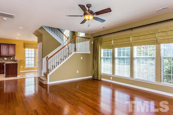 317 Euphoria Circle Cary, NC 27519 - Photo 8 of 22 a view of an entryway with wooden floor and a ceiling fan