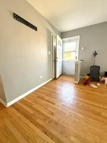 a view of a livingroom with wooden floor and a window