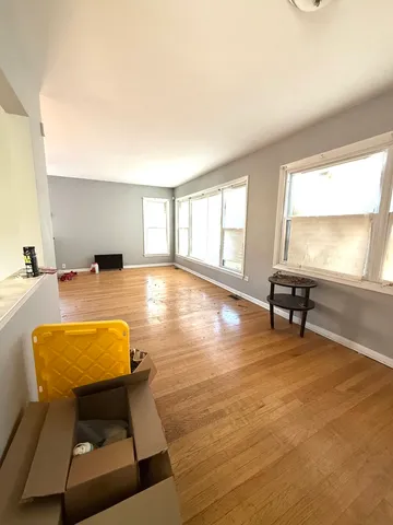 a room with pool table and glass windows