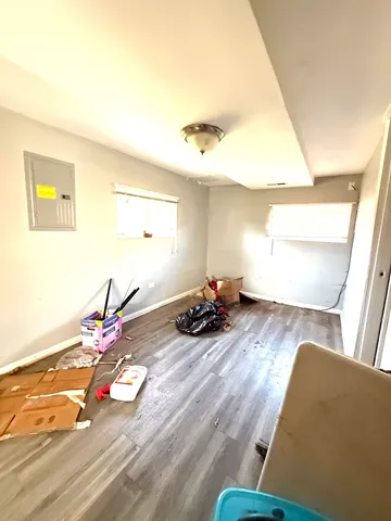 a view of a room with wooden floor and furniture