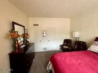 a bedroom with a bed and a potted plant