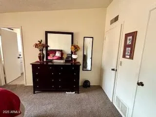 a living room with furniture and a mirror