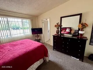 a bedroom with a bed and a dresser in it