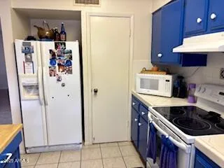 a kitchen with stainless steel appliances granite countertop a refrigerator and a stove