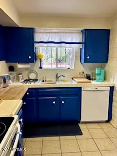 a kitchen with a sink a stove and cabinets
