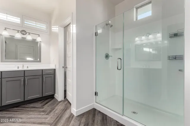 a bedroom with a bed window and a flat screen tv