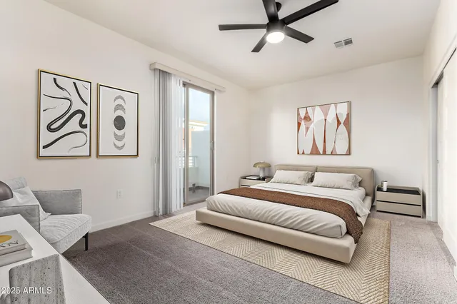 a bedroom with a large bed and a chandelier