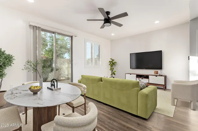 a living room with furniture kitchen and a table