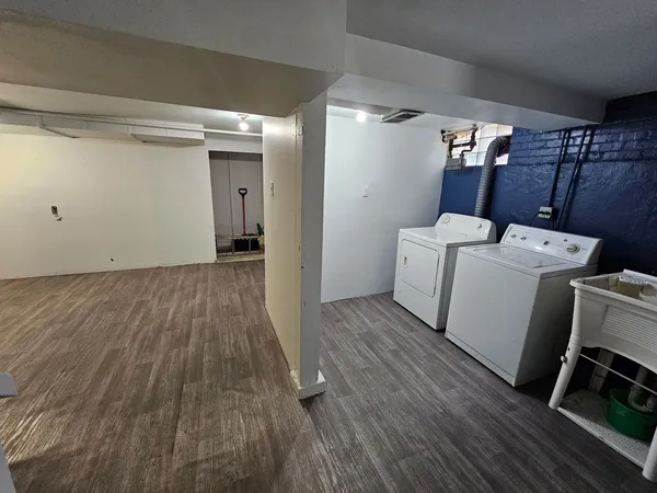a view of a room with wooden floor and utility room