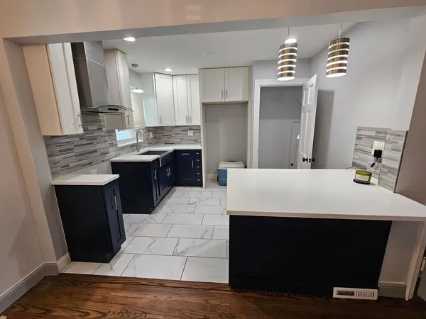 a large kitchen with kitchen island a sink dishwasher stove and refrigerator