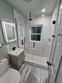 a bathroom with a sink toilet a mirror and tub