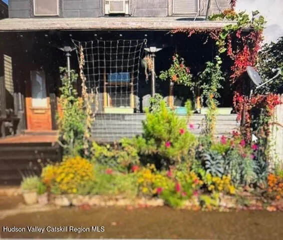 a view of a house with potted plants