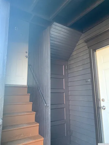 a view of entryway with wooden floor and windows