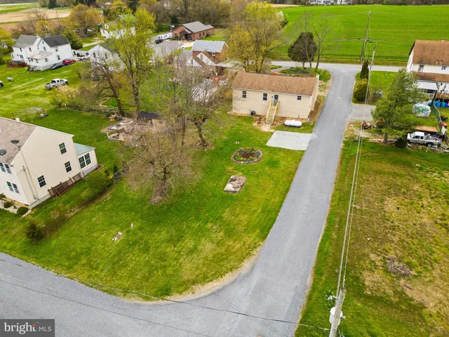 an aerial view of a house with a garden and lake view