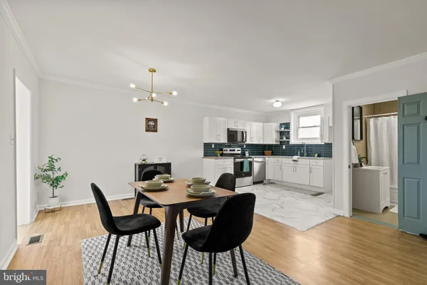 a living room with furniture and kitchen view