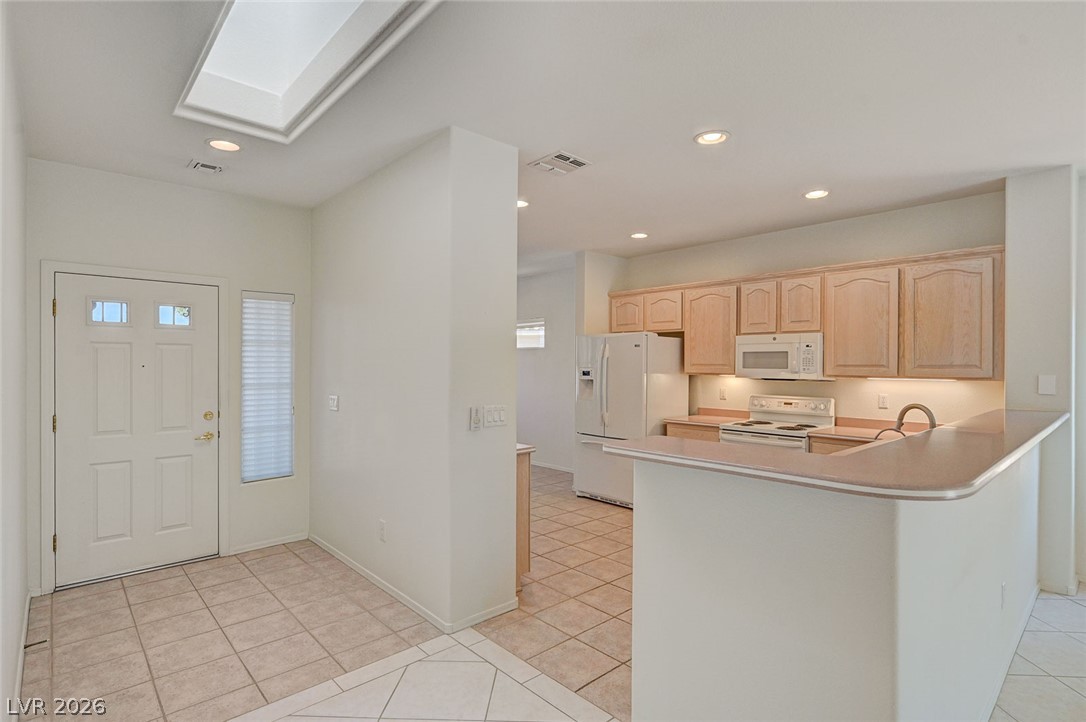 2529 Springville Way Henderson, NV 89052 - Photo 14 of 70 A skylight brightens the welcoming entry and adjacent kitchen featuring tile flooring.