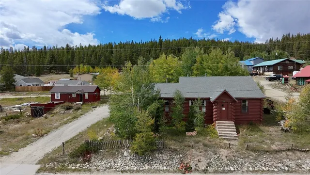 a view of house with a yard and lake view