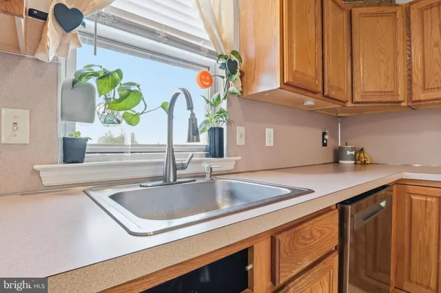 a kitchen with stainless steel appliances granite countertop a sink a counter space and cabinets