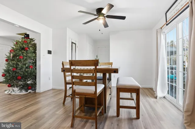 a view of a dining room with furniture window and wooden floor