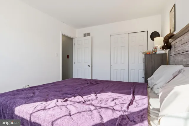 a bedroom with a bed and a mirror