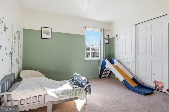 a bedroom with bed and a window