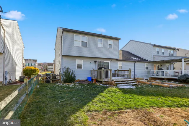 a front view of a house with a yard table and chairs