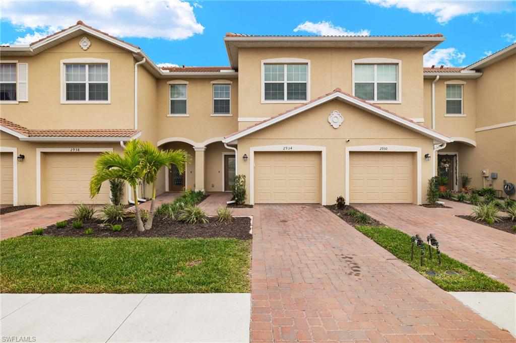2934 Citrus Street Naples, FL 34120 - Photo 2 of 29 a front view of a house with a garden and yard