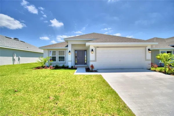 a front view of a house with a garden and patio