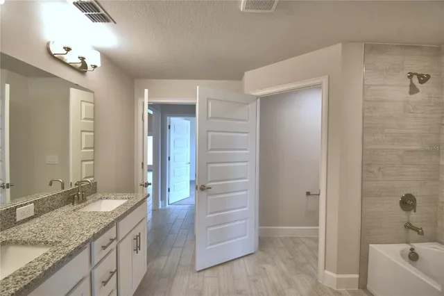 a bathroom with a bathtub and shower