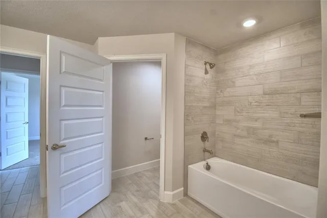 a bathroom with a bathtub and a toilet