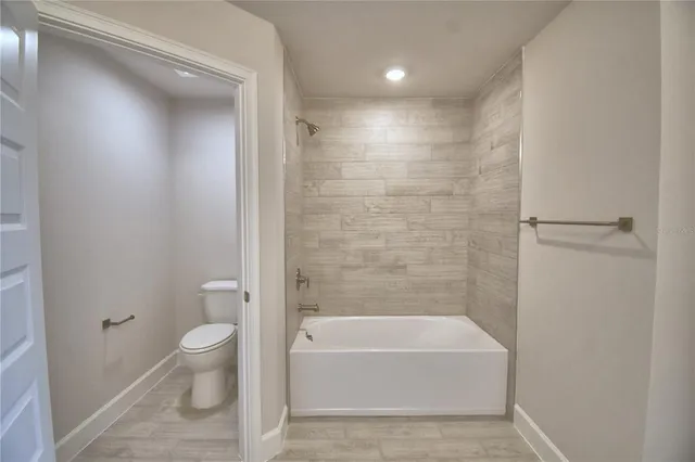 a bathroom with a granite countertop double vanity sink and a mirror